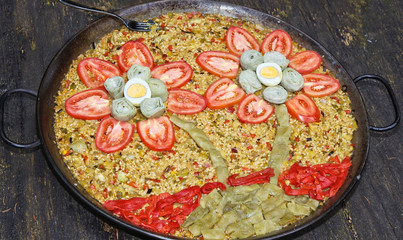 A decorated paella with flowers