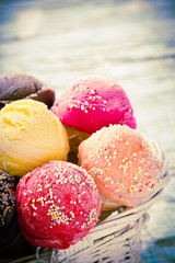 Ice cream scoops on wooden table.