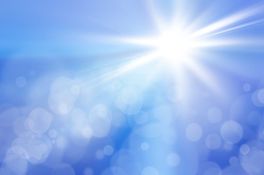 Sun on a blue sky with rays and flare