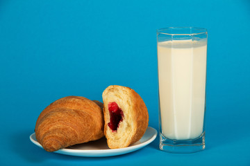 Fresh croissants on saucer and milk
