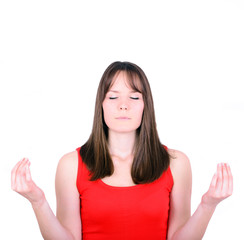 Young girl meditating over white background