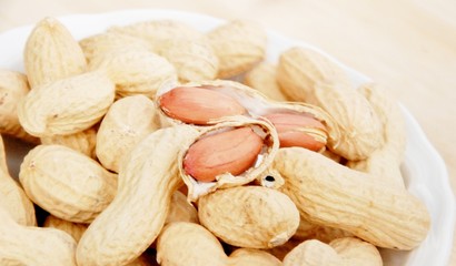 pot with peanuts upward wooden table