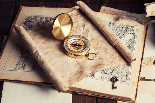 compass and old map on wooden table