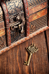 vintage key and old treasure chest on wooden table