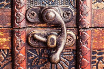 closed treasure chest standing on wooden table