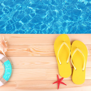 Colored Flip Flops On Wooden Platform Beside Sea