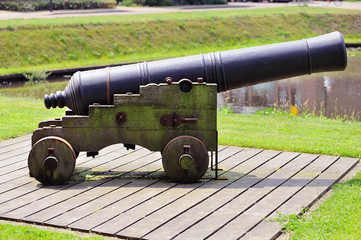 Historic cannon stands ready at the canal