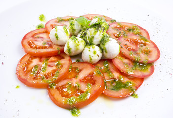 tomatoes and cheese on white plate in a restaurant