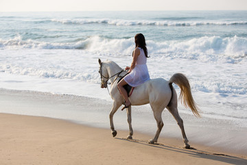 girl horse ride on the beach