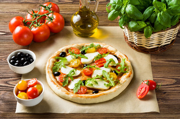 Preparing a pizza on a wooden table