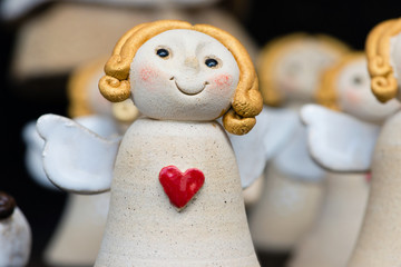 Cute ceramic angel with red heart