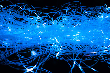 abstract illuminated blue fiber optics cables