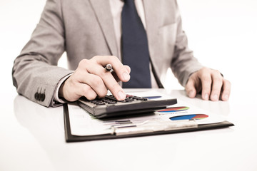 Businessman analyzing investment charts with laptop