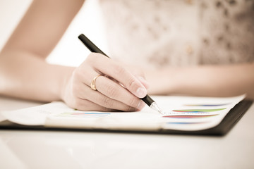 woman hand with pen and business report. Accounting