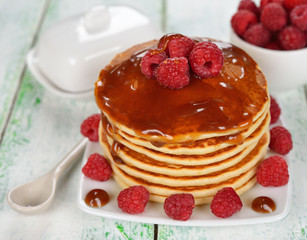 Pancakes with caramel sauce and raspberries