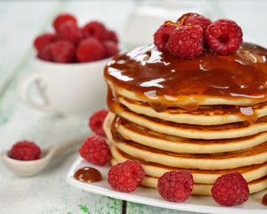 Pancakes with caramel sauce and raspberries