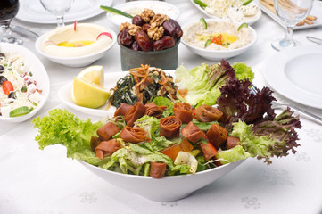 Arabic food of fattoush and hommos cheese and dates