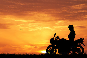 Fototapeta na wymiar Motorcyclist at sunset