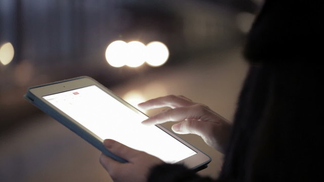 Woman using touchpad in the underground