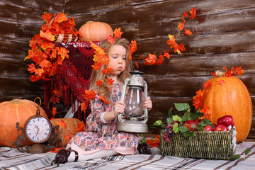 Pretty little girl sits on floor and blows out old lamp in room