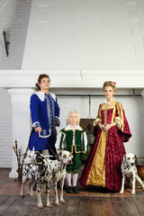 Father, mother and son in bright medieval costume stand