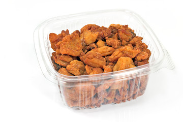 Pork greaves in plastic bowl isolated on white