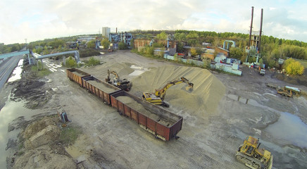 Excavators loaded sand into railway carriages.