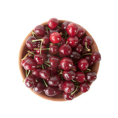 Red cherries in clay bowl isolated on white