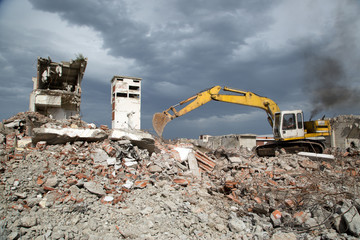 Bulldozer removes the debris from demolition of old buildings