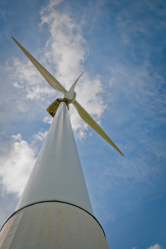 wind turbine blades on blue cloudy sky background