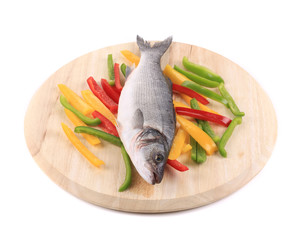 Fresh seabass fish on wooden platter.