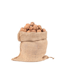 Burlap sack full of walnuts.