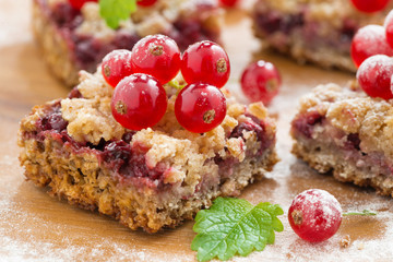 berry tart with fresh red currants on wooden board