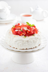 cake with whipped cream, strawberries on stand, tea accessories