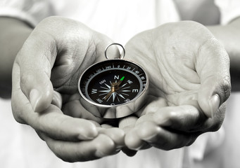 two hands show a compass