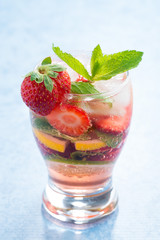 cocktail with fresh strawberries and citrus