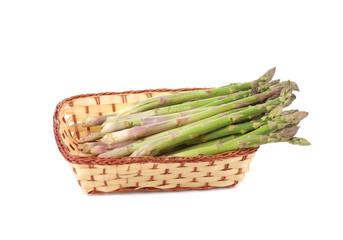 Wicker basket full with asparagus.