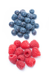 fresh raspberries and blueberries, top view, isolated