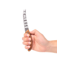 Hand holds cheese knife.