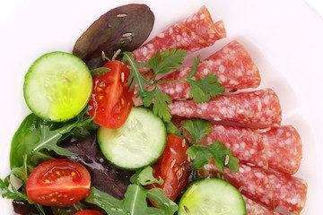 Fresh salad with salami.