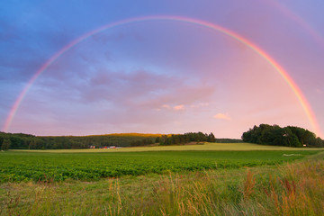 Rainbow over Swedish farm field