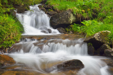 Fototapeta na wymiar Mountain river with cascades