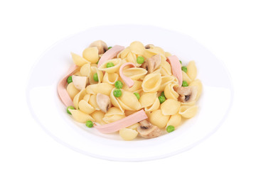 Pasta shells with vegetables on white plate.