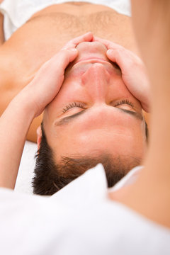 Close-up of young man getting face massage