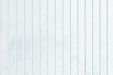 untidy white metal wall with straight vertical grooves