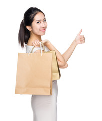 Happy girl with shopping bag and thumb up