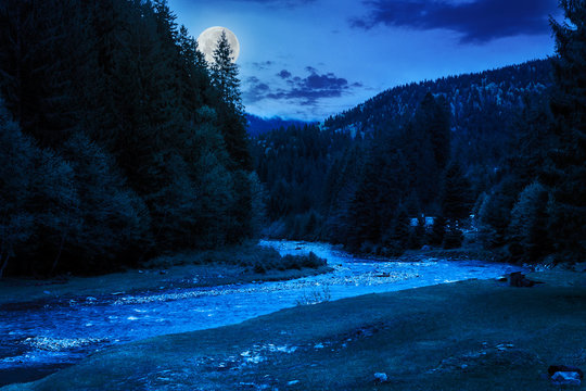 camping place near mountain river at night