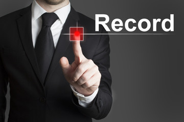 businessman in black suit pushing red touchscreen button record