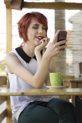 Hipster girl text messaging on her smart phone