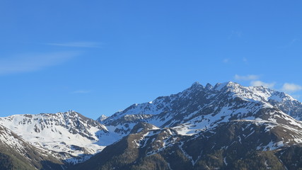 Fototapeta na wymiar rocky mountains and snow and blue sky
